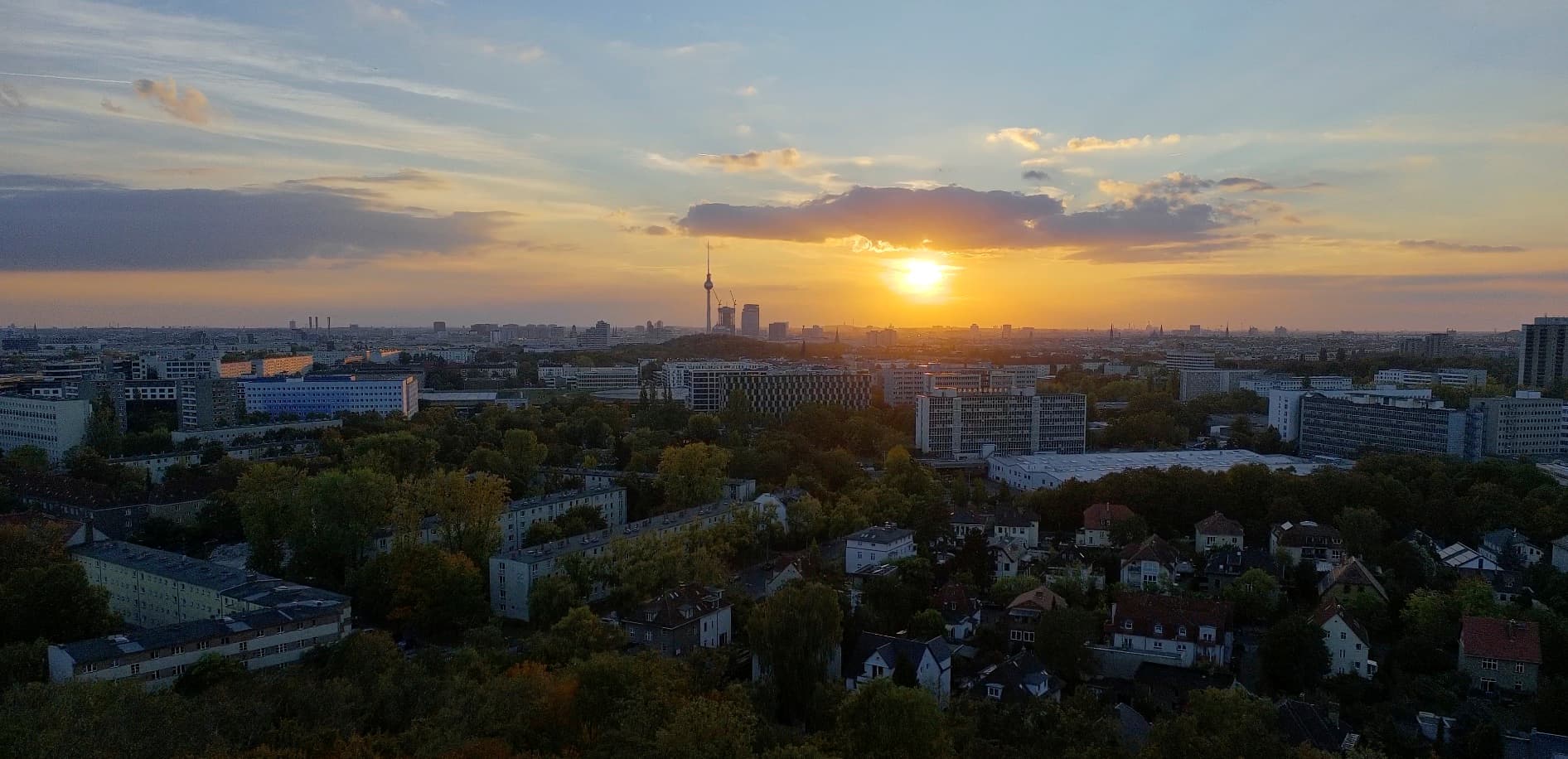 Berlin skyline at sunset with the TV Tower in the distance.